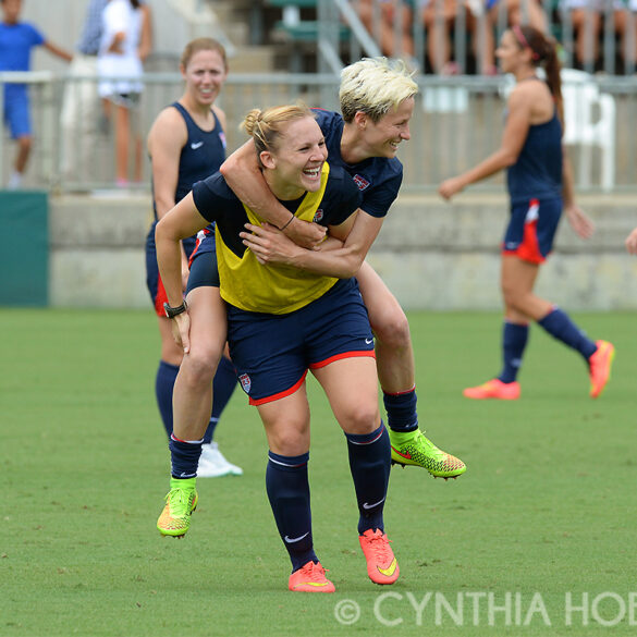 Amy Rodriguez gives Megan Rapinoe a lift during U.S. Women's National Team open training on August 19, 2014, in Cary, N.C.
