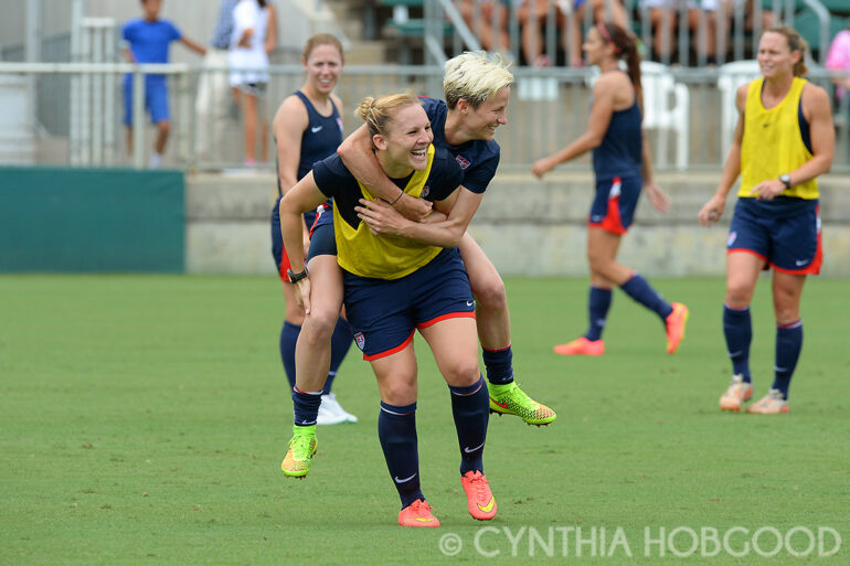 Amy Rodriguez gives Megan Rapinoe a lift during U.S. Women's National Team open training on August 19, 2014, in Cary, N.C.