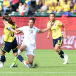 Carli Lloyd goes into a tackle against Natalia Gaitán.