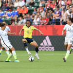 The USA's Carli Lloyd (10) and Lauren Holiday (12) against Colombia's Lady Andrade (16).