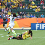 The USA's Alex Morgan avoids a tackle by Colombia's Nataly Arias.