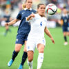 England's Fara Williams (4) and France's Camille Abily.