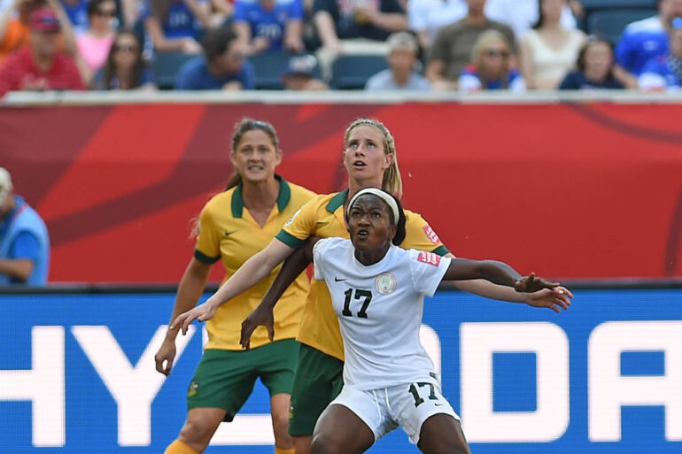 Nigeria's Francisca Ordega holds off the Australian defense.