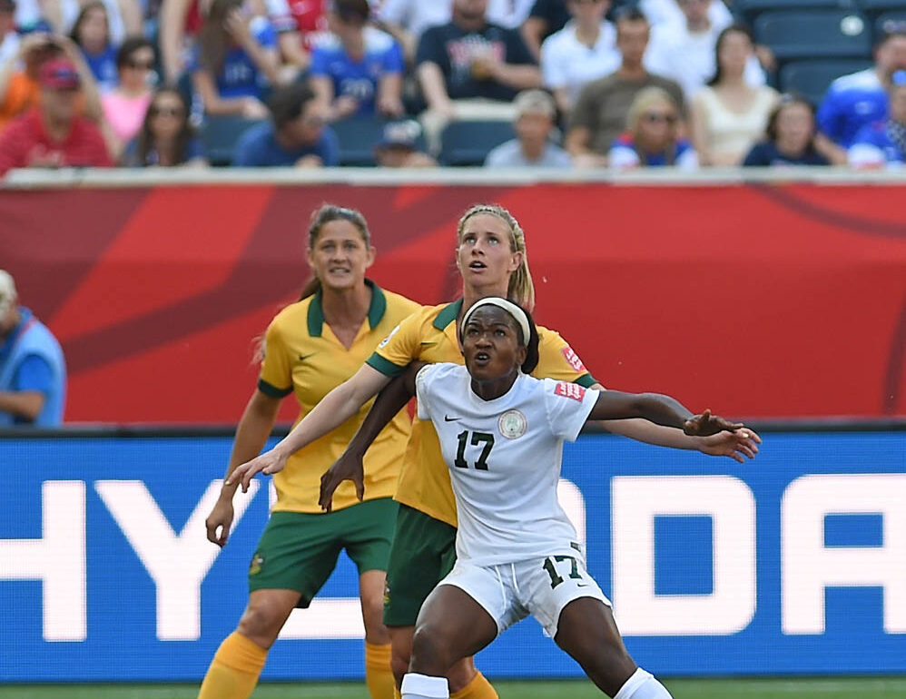 Nigeria's Francisca Ordega holds off the Australian defense.