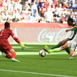 Julie Johnston (19) tackles the ball away from Asisat Oshoala.