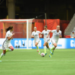 USA's Abby Wambach looks for Alex Morgan.