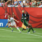 USA's Christie Rampone shields the ball from Nigeria's Asisat Oshoala.