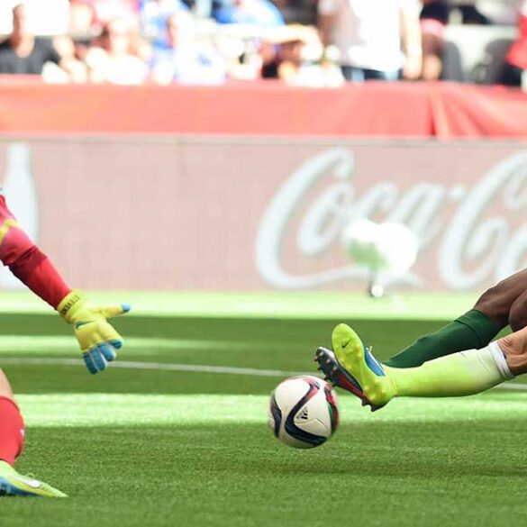 Julie Johnston tackles the ball away from Asisat Oshoala.