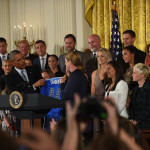 U.S. Women's National Team head coach Jill Ellis presents President Obama with a jersey during the USWNT's visit to the White House.