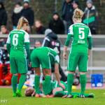 Werder Bremen players check on their teammate.