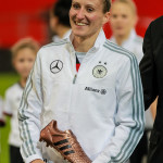 Anja Mittag and her FIFA Bronze Boot award won during the 2015 Women's World Cup.