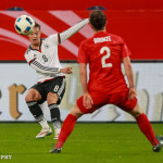 Germany's Felicitas Rauch takes a shot while England's Lucy Bronze defends.