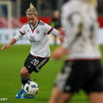 Lena Goeßling (GER) maneuvers with the ball.