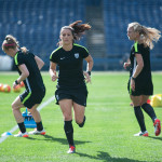 Becky Sauerbrunn, Ali Krieger, and Whitney Engen warming up during pregame practice.