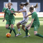 Tobin Heath tries to maneuver past Ruesha Littlejohn (9) and Louise Quinn (4)