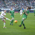USA's Heather O'Reilly takes a shot while Ireland's Julie Ann Russell and Megan Campbell defend.