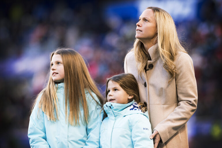 Christie Rampone and her daughters at a pregame ceremony honoring Rampone for her USWNT career.