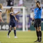 Allie Long in discussion with the referee Shane Lardinois).