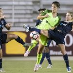 Kristen Hamilton (23), Katie Johnson (middle), and McCall Zerboni (right) vie for the ball. Muscles McCall. (Shane Lardinois)