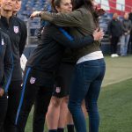 Carli Lloyd hugs Hope Solo before Solo is honored for earning 200 caps with the U.S. (Manette Gonzales)