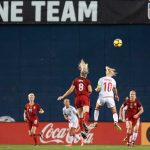 Julie Ertz and Pernille Harder get up. (Manette Gonzales)