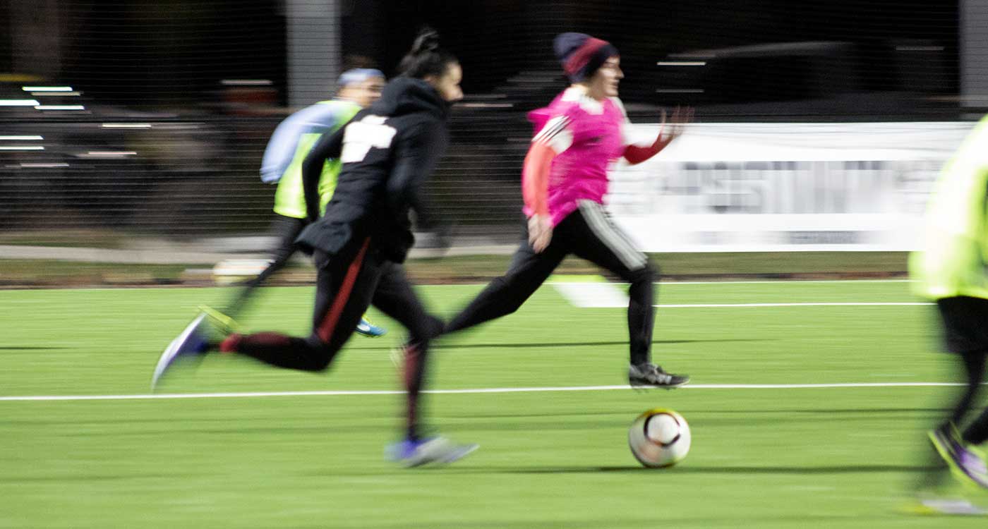 Ali Krieger playing at her AKFC Adult Camp in a motion blur.