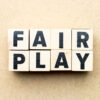 "Fair Play" spelled out in wooden blocks.