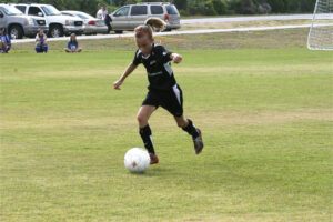 Martha Thomas with the ball as a young soccer player. (Thomas family)