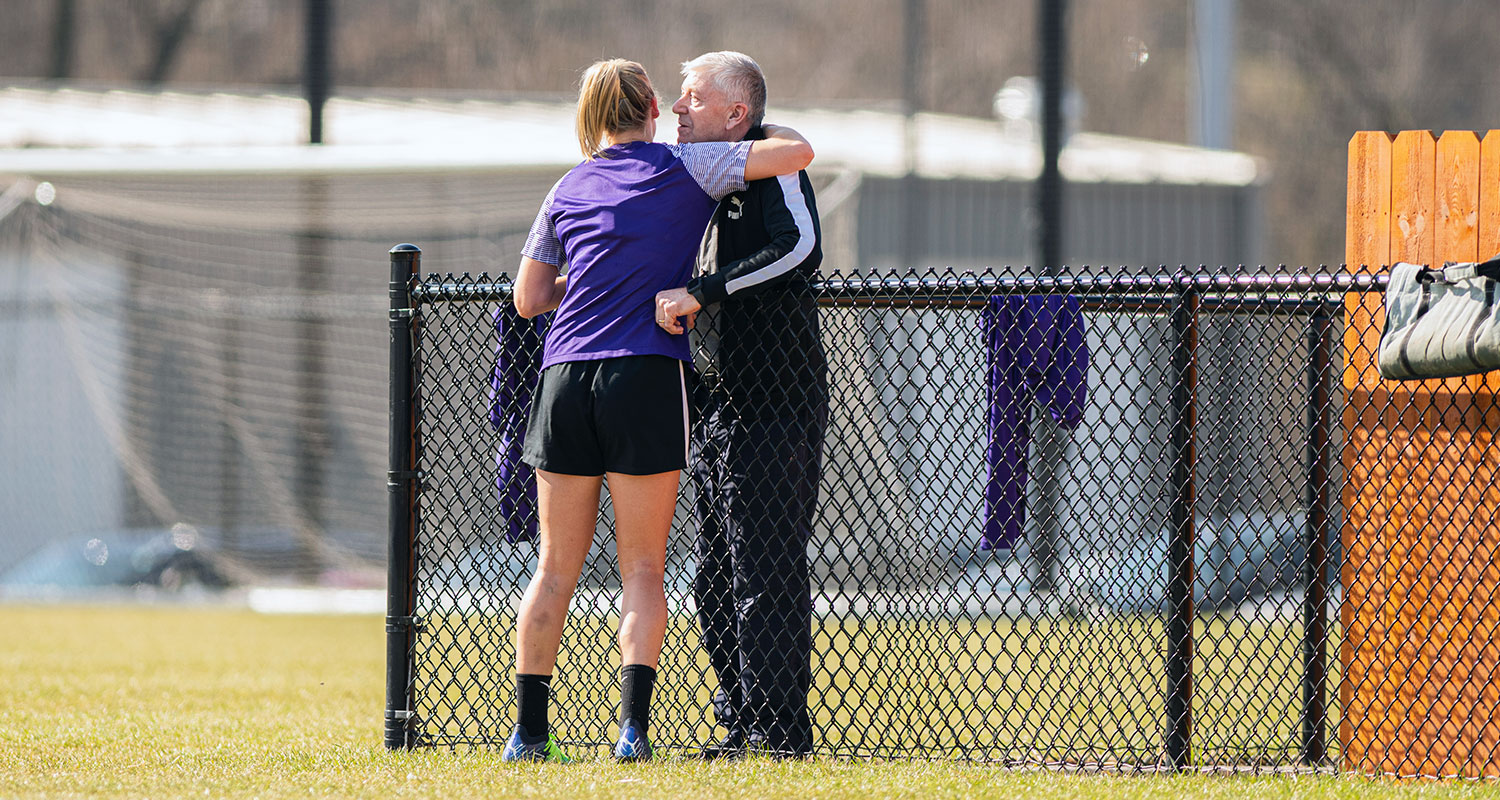 Defender Gemma Bonner greets her father after being apart for two years at training. (Conor Cunningham / Racing Louisville FC)
